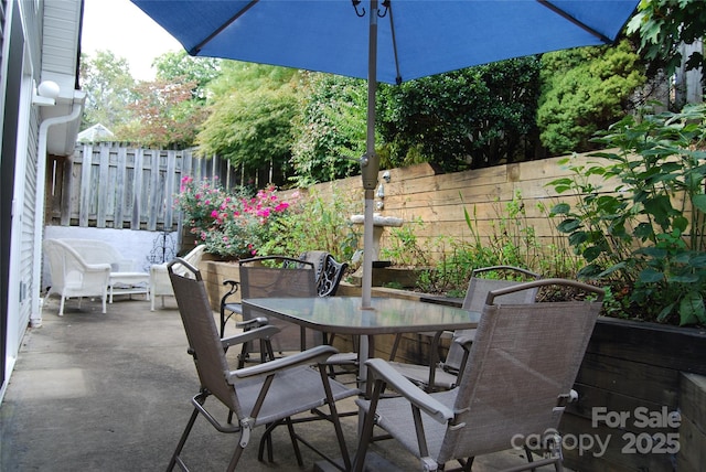 view of patio / terrace featuring outdoor dining area and fence private yard