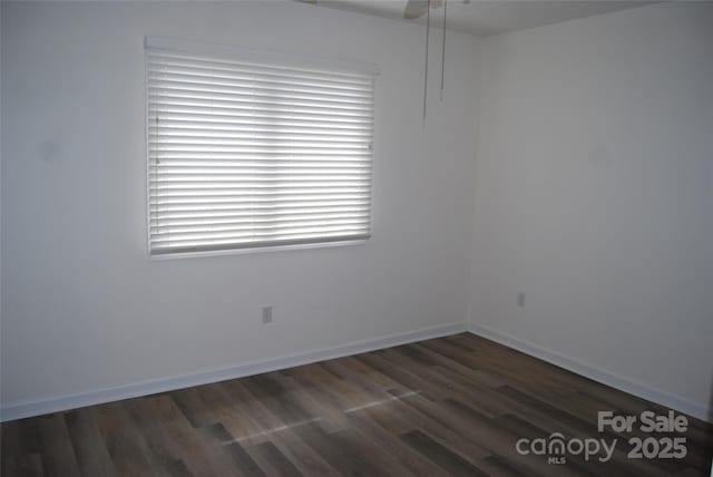 empty room featuring baseboards and wood finished floors