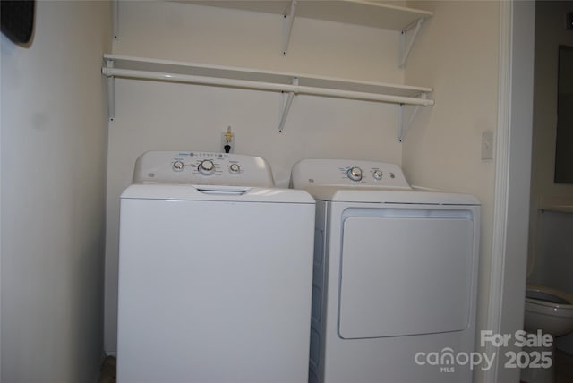 clothes washing area with laundry area and washing machine and dryer