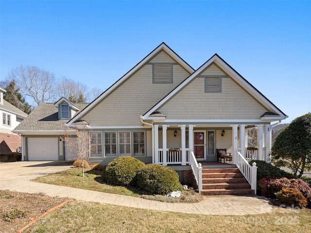 view of front of home with a garage, covered porch, and driveway