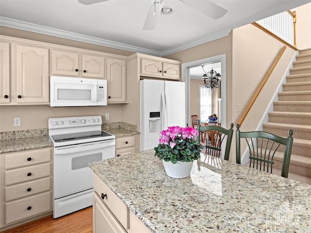 kitchen with white appliances, ornamental molding, light stone counters, light wood-style floors, and ceiling fan with notable chandelier