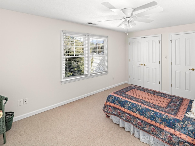 bedroom featuring carpet floors, a ceiling fan, visible vents, and baseboards