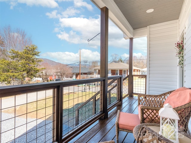 balcony featuring a residential view and a mountain view