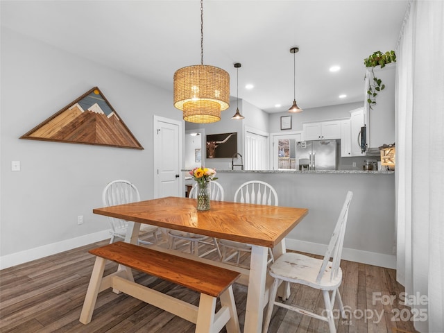 dining space featuring recessed lighting, wood finished floors, and baseboards