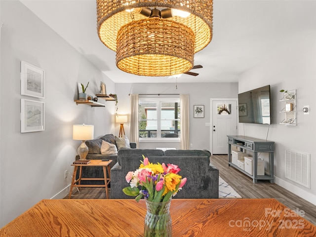 dining room featuring visible vents, baseboards, and wood finished floors