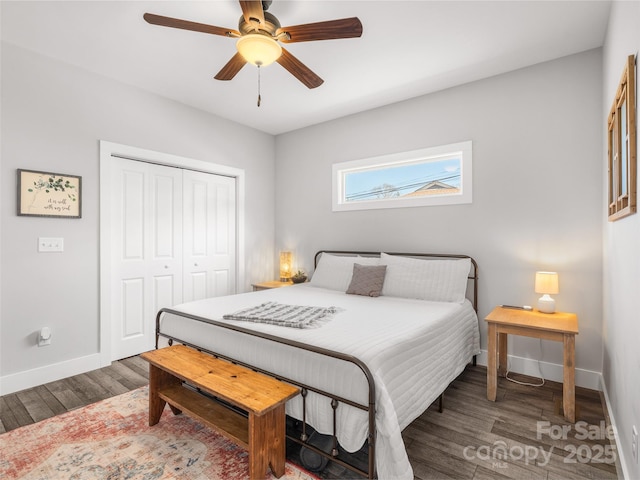 bedroom featuring a closet, wood finished floors, a ceiling fan, and baseboards