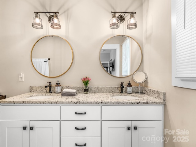 bathroom with a sink and double vanity