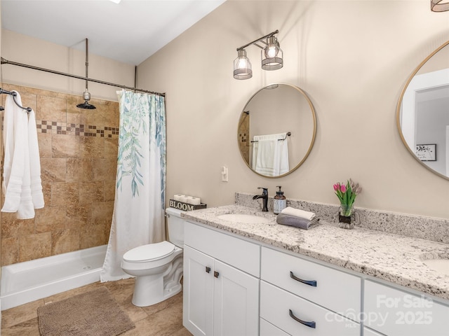 full bathroom featuring tiled shower, a sink, toilet, and double vanity