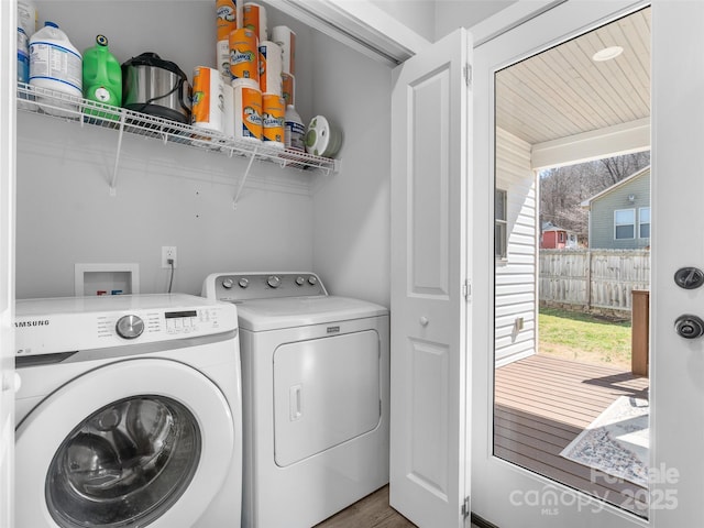 clothes washing area featuring laundry area and washing machine and clothes dryer