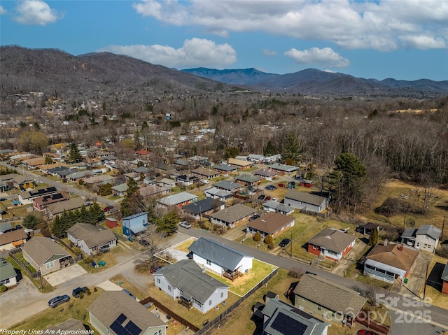 birds eye view of property with a mountain view and a residential view