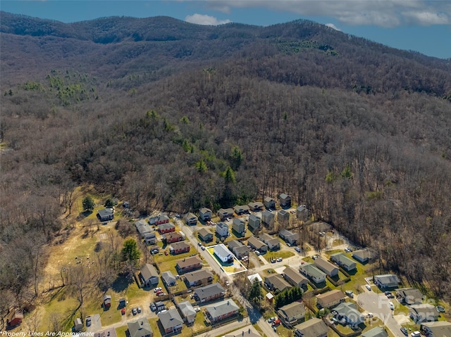 birds eye view of property with a forest view, a residential view, and a mountain view