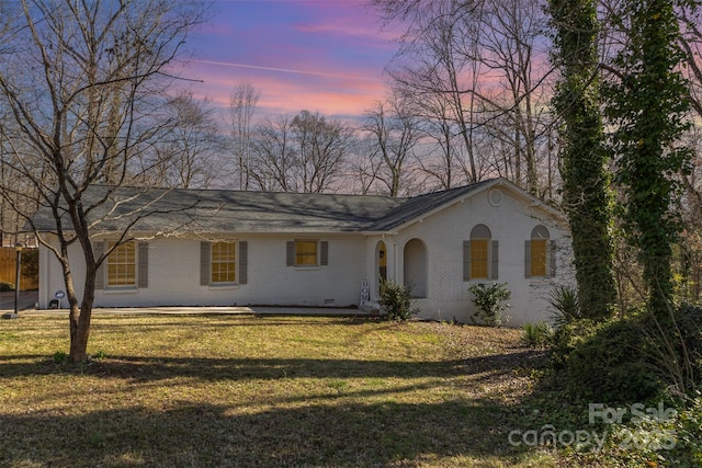 view of front of property with brick siding and a front yard