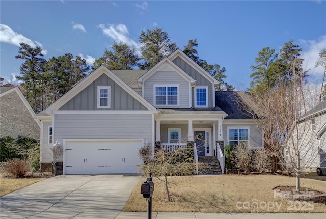 craftsman-style house with board and batten siding, a porch, and driveway