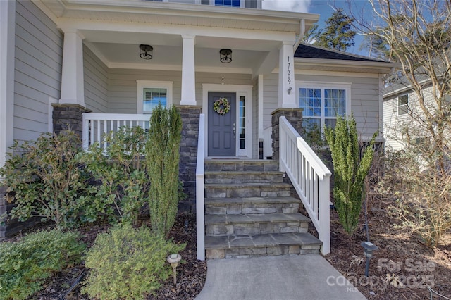 entrance to property featuring a porch