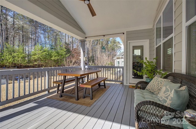 wooden terrace featuring ceiling fan and outdoor dining area