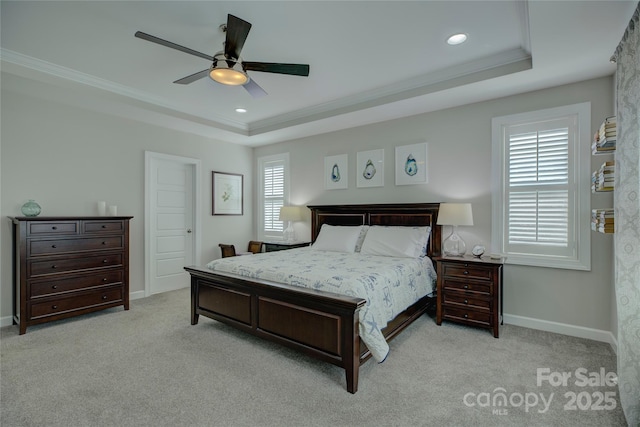 bedroom featuring carpet floors, a tray ceiling, and ornamental molding