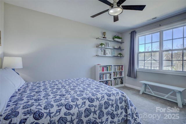 carpeted bedroom featuring a ceiling fan, visible vents, and baseboards