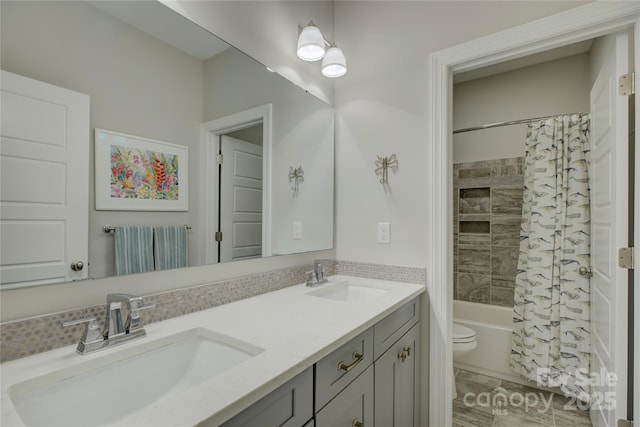 full bathroom featuring shower / tub combo, a sink, toilet, and double vanity