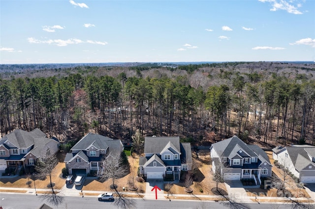 aerial view featuring a residential view and a wooded view