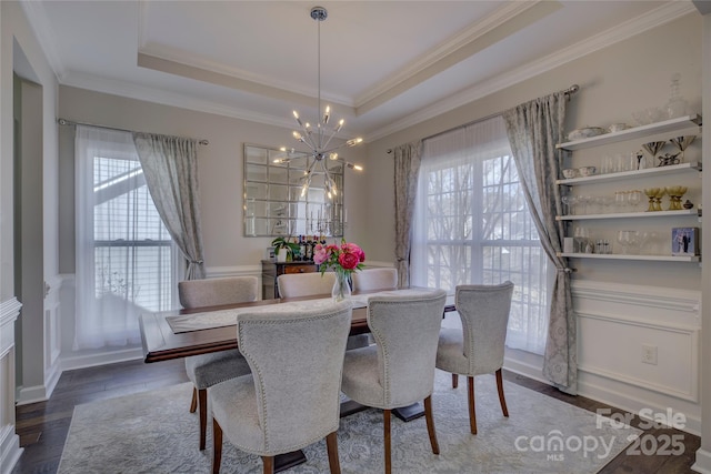17609 Caddy Ct, Charlotte, NC 28278 - dining area featuring a tray ceiling, crown molding, wood finished floors, and a chandelier