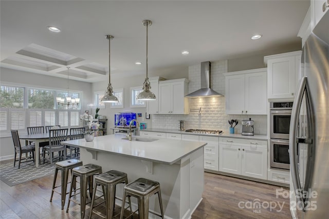 17609 Caddy Ct, Charlotte, NC 28278 - kitchen featuring a sink, coffered ceiling, stainless steel appliances, wall chimney range hood, and decorative backsplash