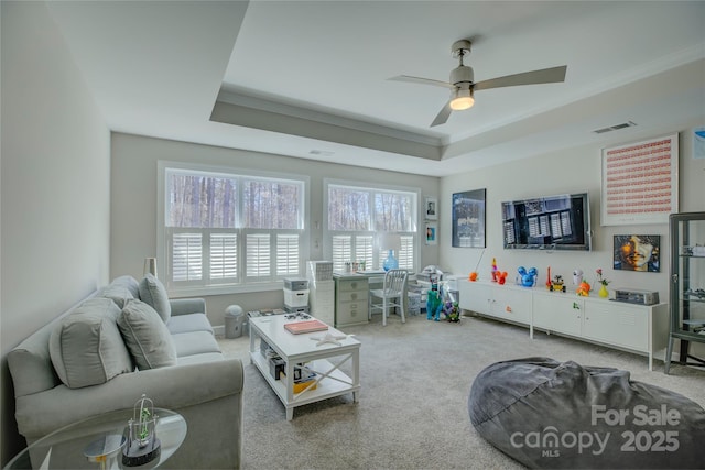 17609 Caddy Ct, Charlotte, NC 28278 - carpeted living area featuring visible vents, a raised ceiling, ceiling fan, and crown molding