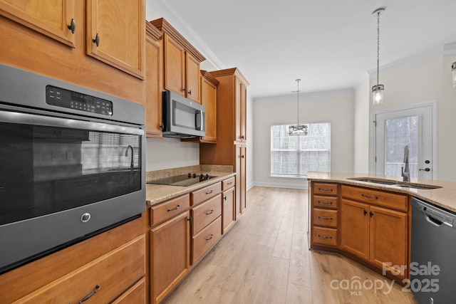 kitchen featuring appliances with stainless steel finishes, brown cabinets, crown molding, and a sink