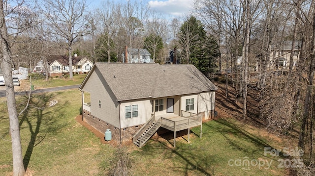 exterior space with a shingled roof, stairway, crawl space, a wooden deck, and a front yard