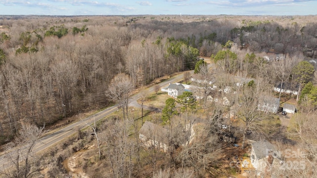 bird's eye view featuring a wooded view