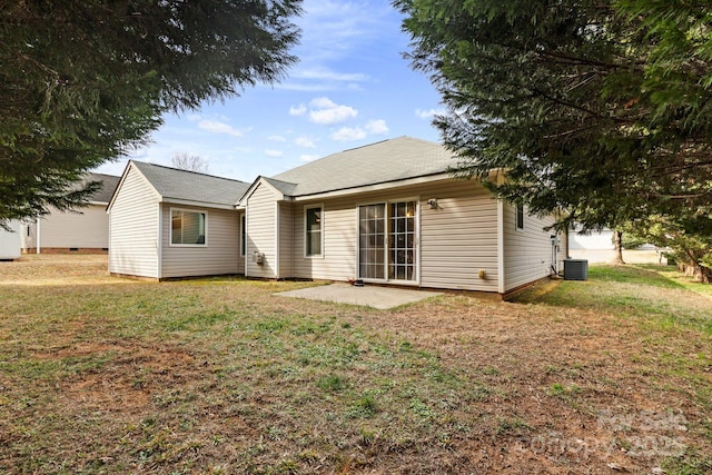 rear view of property with a yard, a patio, and central air condition unit