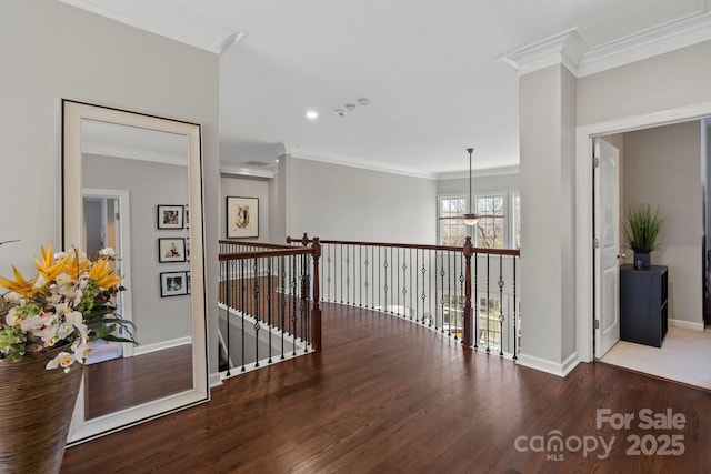 hallway with wood finished floors, baseboards, and ornamental molding