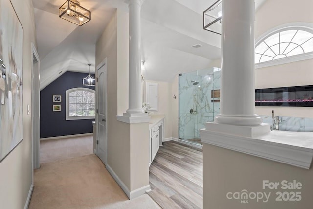 bathroom featuring vanity, a stall shower, and ornate columns