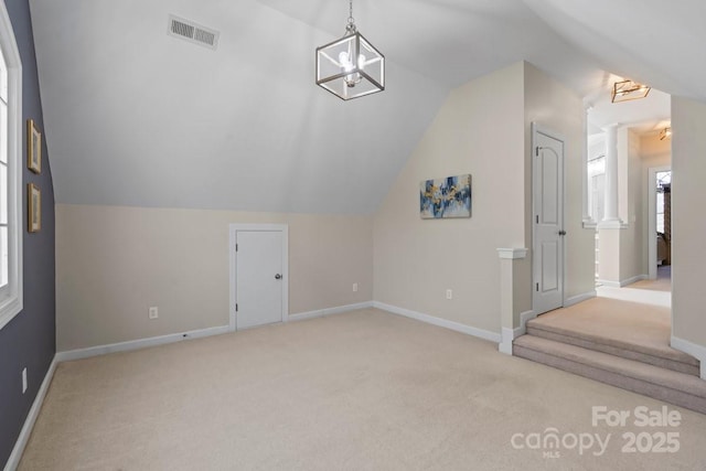 additional living space with lofted ceiling, baseboards, visible vents, and carpet floors