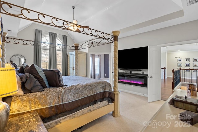 bedroom featuring carpet flooring, baseboards, visible vents, and vaulted ceiling