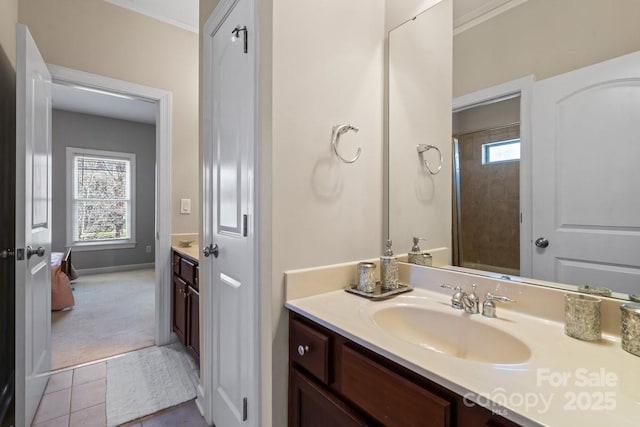 bathroom featuring vanity, tile patterned floors, and ornamental molding