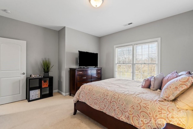 bedroom featuring visible vents, baseboards, and light colored carpet