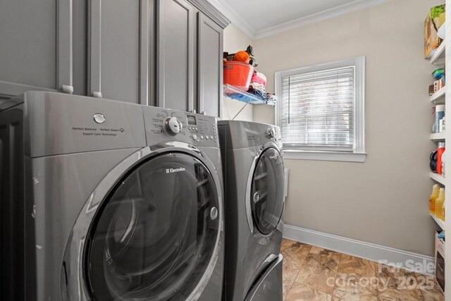 washroom featuring cabinet space, ornamental molding, baseboards, and separate washer and dryer