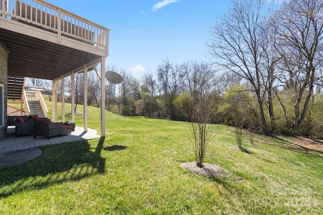 view of yard with stairway, a wooden deck, and a patio area