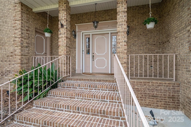 property entrance with brick siding