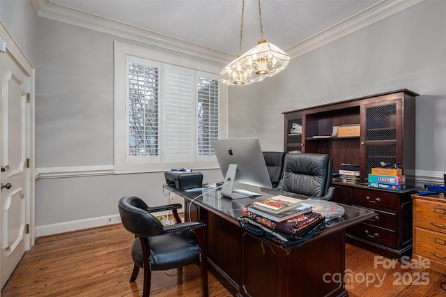 office with baseboards, an inviting chandelier, wood finished floors, and crown molding