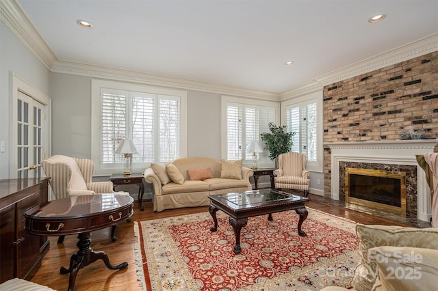 living area with recessed lighting, wood finished floors, and crown molding