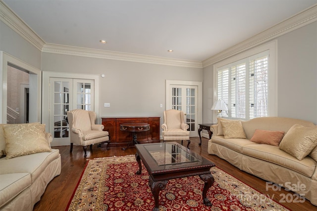 living room with a wealth of natural light, wood finished floors, and crown molding