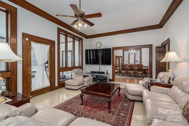 tiled living area with ceiling fan with notable chandelier and crown molding