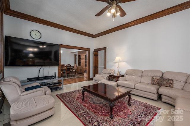 living room with tile patterned flooring, ornamental molding, and ceiling fan