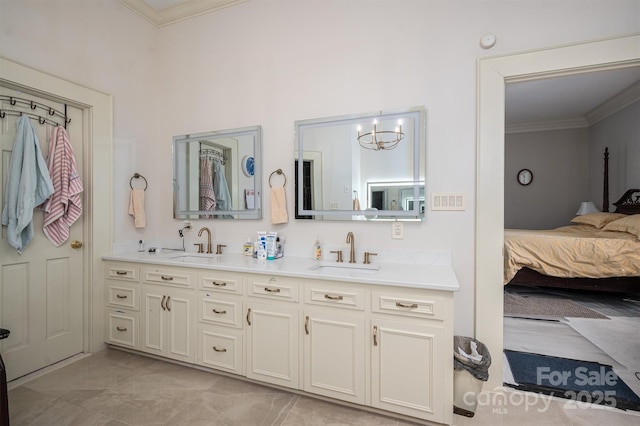 full bath with an inviting chandelier, ornamental molding, ensuite bathroom, and a sink