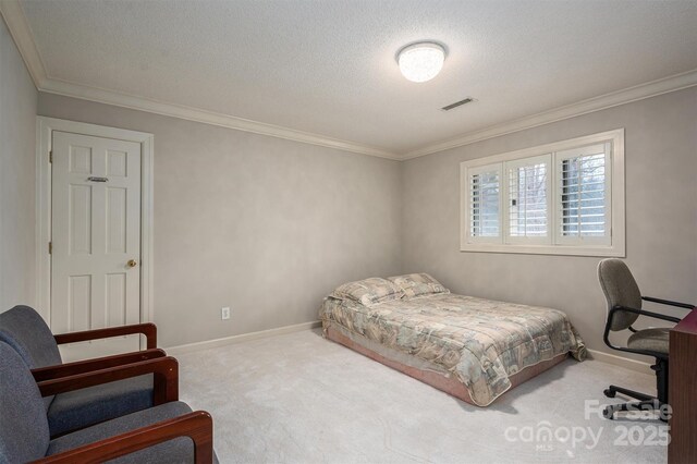 bedroom featuring a textured ceiling, carpet, baseboards, and ornamental molding