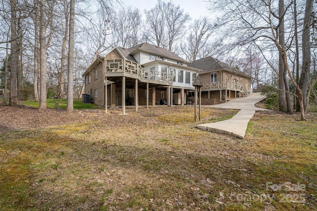 rear view of property with a deck and central AC