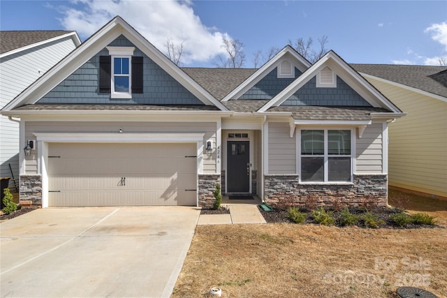 craftsman-style home featuring driveway, stone siding, an attached garage, and a shingled roof