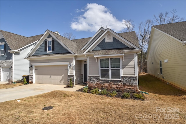 craftsman-style house with roof with shingles, a garage, stone siding, driveway, and a front lawn