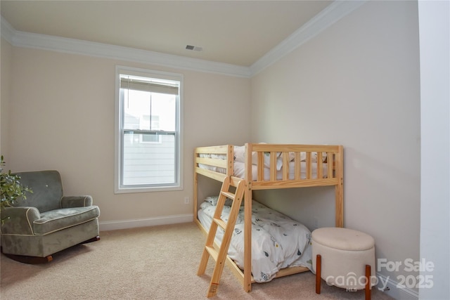 carpeted bedroom featuring baseboards, visible vents, and ornamental molding